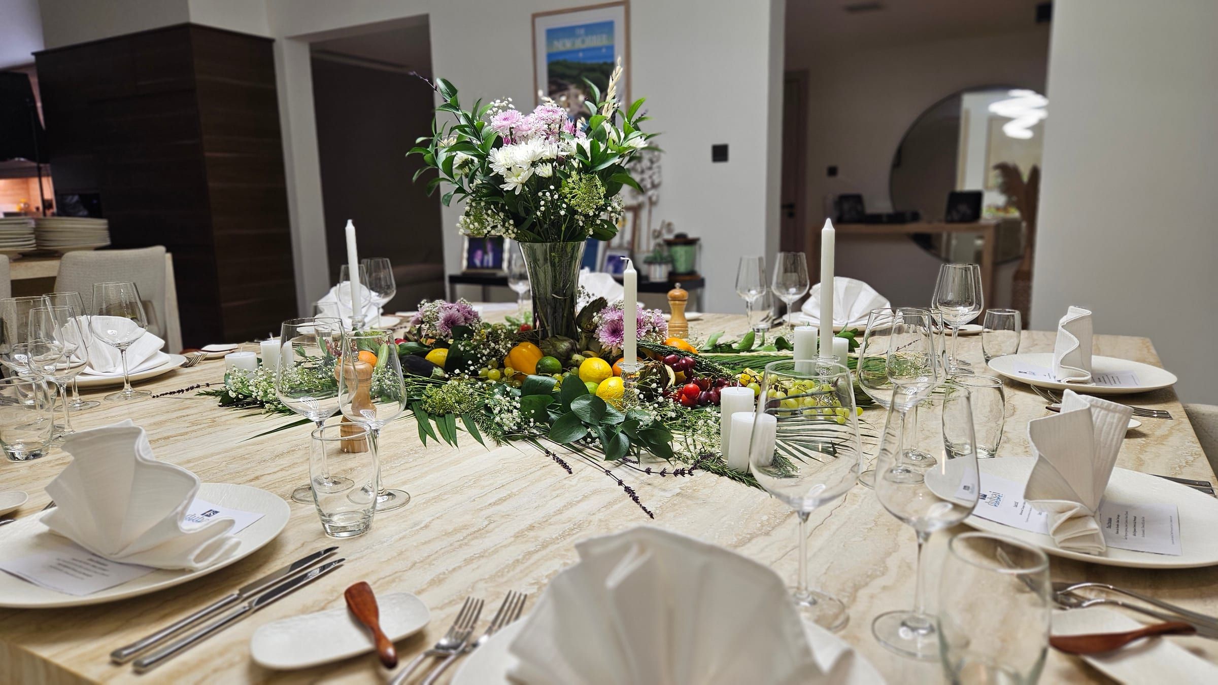 A Dubai dining table dressed for the evening with plates, glasses, linen and flowers.